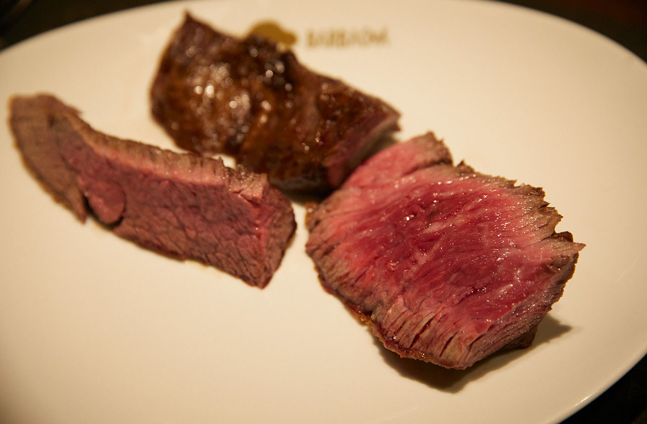 キッチンとテーブルを仕切って調理と配膳を分業するレストランや、キッチンとテーブルを仕切らずカウンター席で店主などが調理と配膳を兼業する日本の割烹料理や寿司のような外食モデルはあるが、パサドールのようにキッチンとテーブルが仕切られた空間を、調理と配膳を兼業して行き来する例はとても珍しい外食モデルといえる。